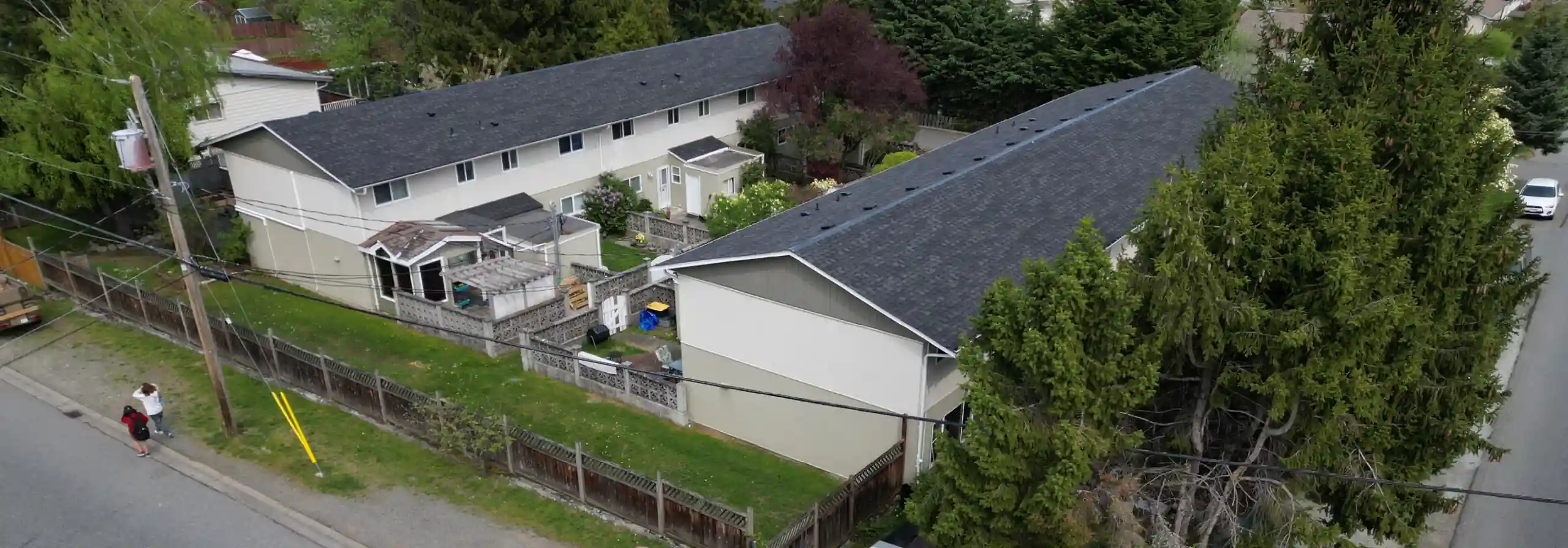 Drone photo showing a pair of 1970s 2-storey townhome buildings with a walkway between them