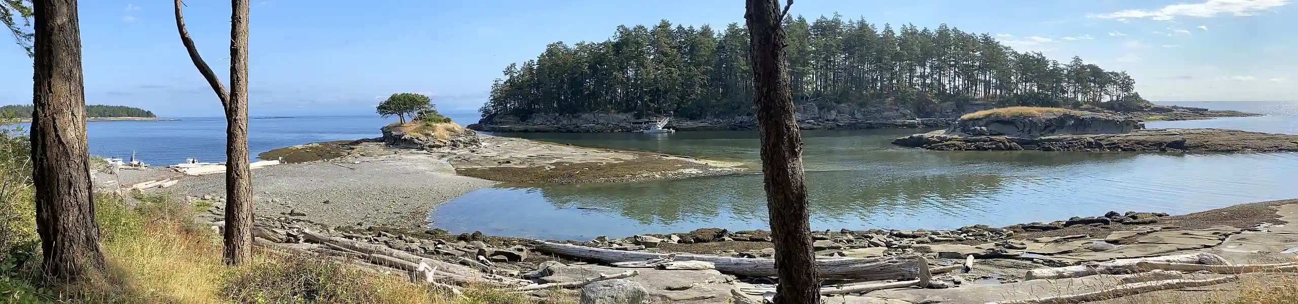 Photo showing a sandstone beach with small islands - a scene typical of BC's Gulf Islands